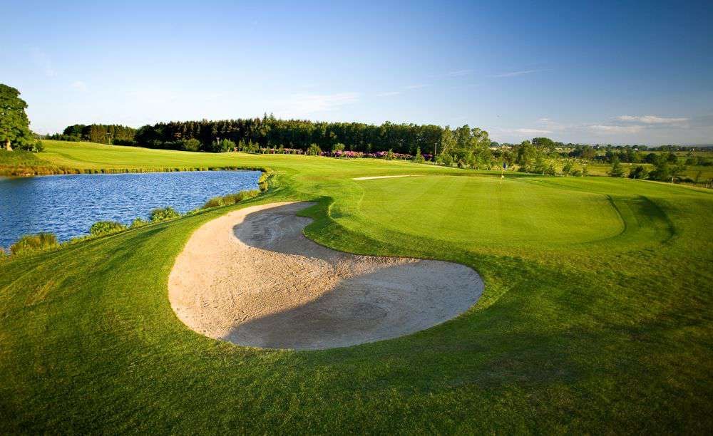 Slaley Hall Priestman course green beside the water and bunker